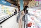 A woman wearing a face mask in a grocery store.