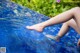 A woman's legs are submerged in a pool of water.