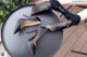 A pair of black high heels sitting on top of a table.